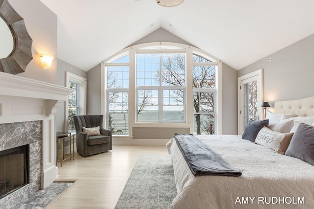 1749 Sunset Point Dr, Norton Shores, MI 49441 - bedroom with a fireplace, lofted ceiling, and wood finished floors