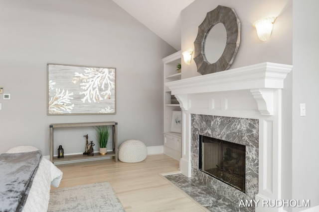 1749 Sunset Point Dr, Norton Shores, MI 49441 - bedroom with a fireplace, wood finished floors, vaulted ceiling, and baseboards