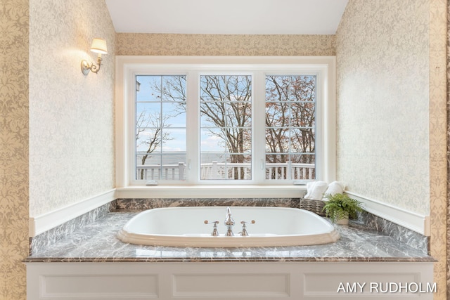 1749 Sunset Point Dr, Norton Shores, MI 49441 - bathroom with wallpapered walls, a bathtub, and lofted ceiling