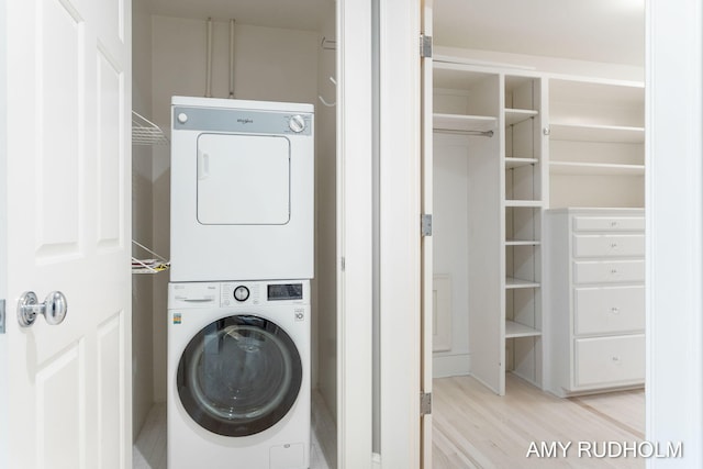 1749 Sunset Point Dr, Norton Shores, MI 49441 - laundry room with stacked washer / drying machine and light wood-type flooring