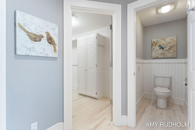 1749 Sunset Point Dr, Norton Shores, MI 49441 - bathroom featuring wood finished floors, a wainscoted wall, and toilet