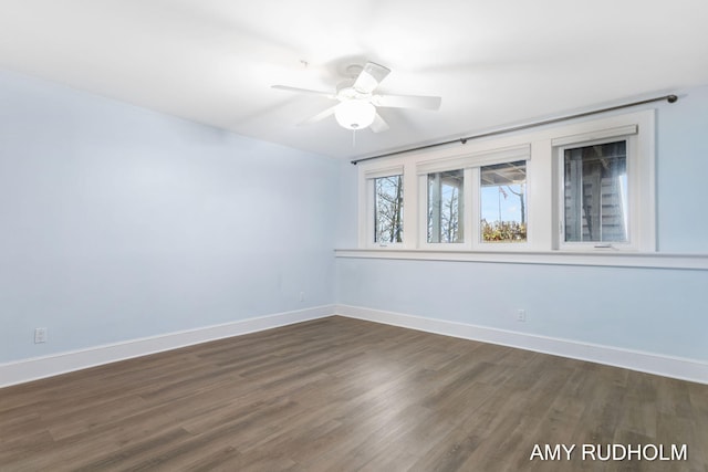 1749 Sunset Point Dr, Norton Shores, MI 49441 - spare room with baseboards, ceiling fan, and dark wood-style floors