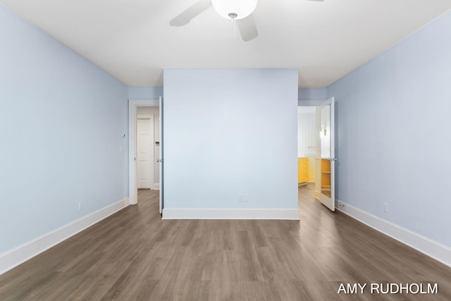 1749 Sunset Point Dr, Norton Shores, MI 49441 - unfurnished bedroom featuring wood finished floors, baseboards, and a ceiling fan