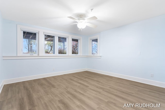 1749 Sunset Point Dr, Norton Shores, MI 49441 - spare room with ceiling fan, baseboards, and wood finished floors