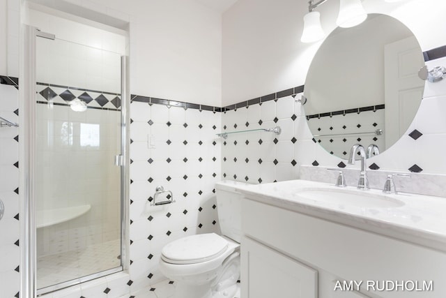 1749 Sunset Point Dr, Norton Shores, MI 49441 - bathroom with tile walls, a stall shower, vanity, and toilet