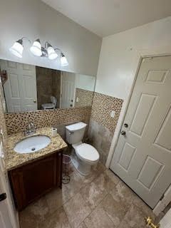 bathroom with tile patterned floors, vanity, and toilet