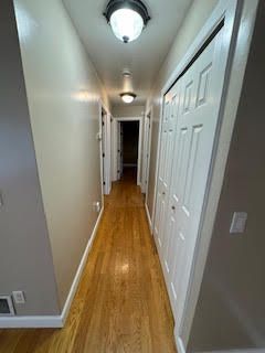 corridor with light hardwood / wood-style floors