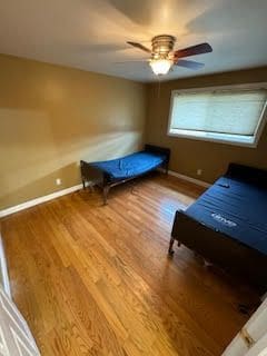 unfurnished bedroom featuring ceiling fan and hardwood / wood-style flooring