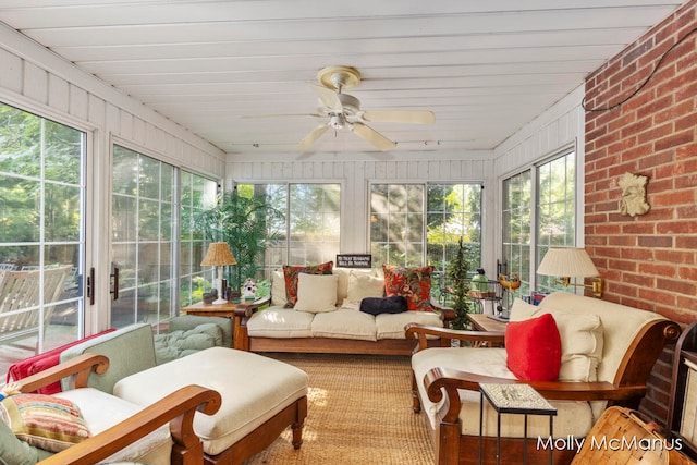 sunroom featuring ceiling fan and plenty of natural light