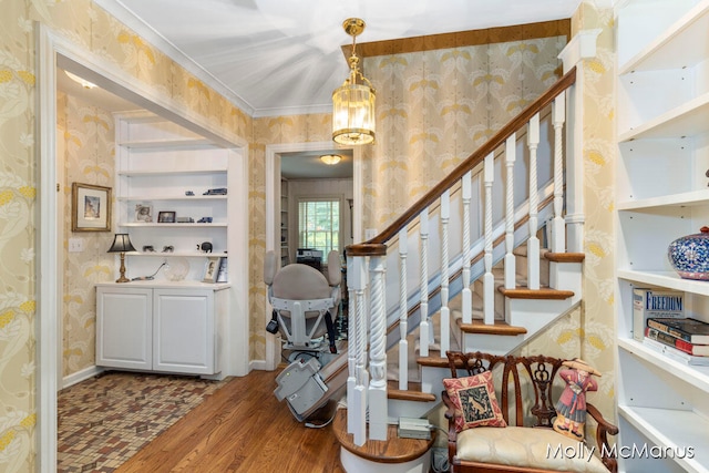 entryway featuring crown molding and hardwood / wood-style floors