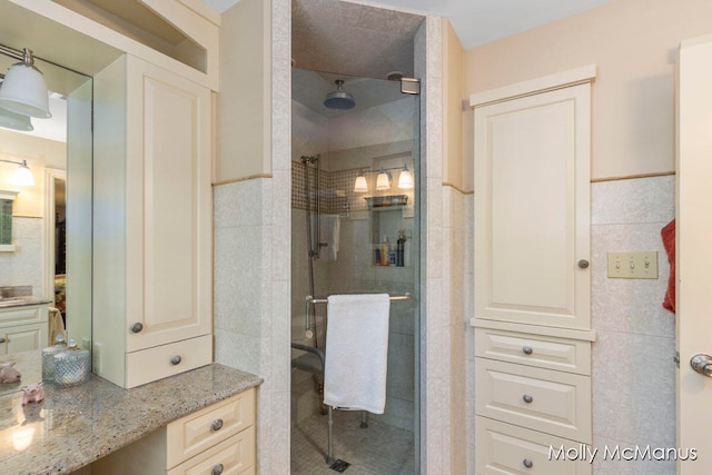 bathroom with walk in shower and tile walls