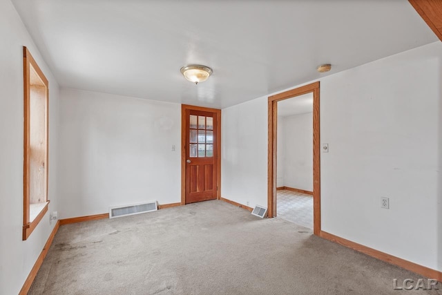 view of carpeted foyer entrance