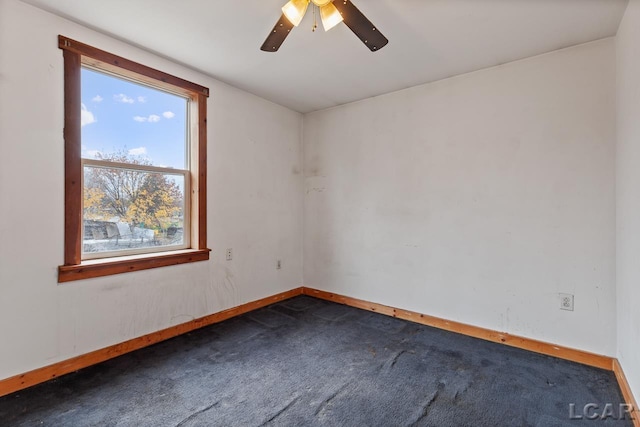 carpeted spare room featuring ceiling fan