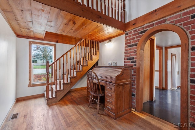 staircase with hardwood / wood-style floors and wood ceiling