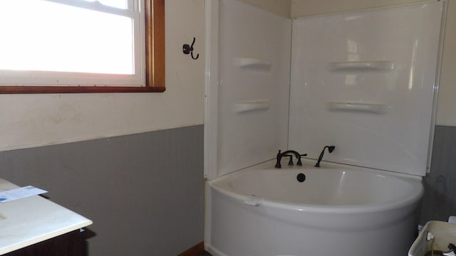 bathroom with a bathing tub and vanity