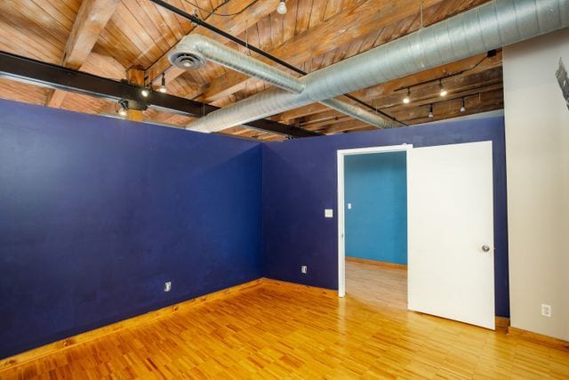 interior space featuring hardwood / wood-style floors, wood ceiling, and track lighting