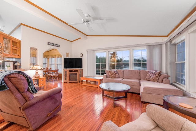 living room featuring hardwood / wood-style floors, vaulted ceiling, ceiling fan, and ornamental molding