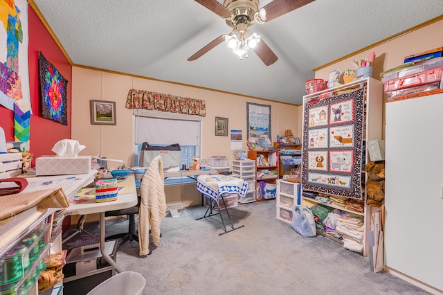 bedroom with ceiling fan, crown molding, carpet floors, and a textured ceiling