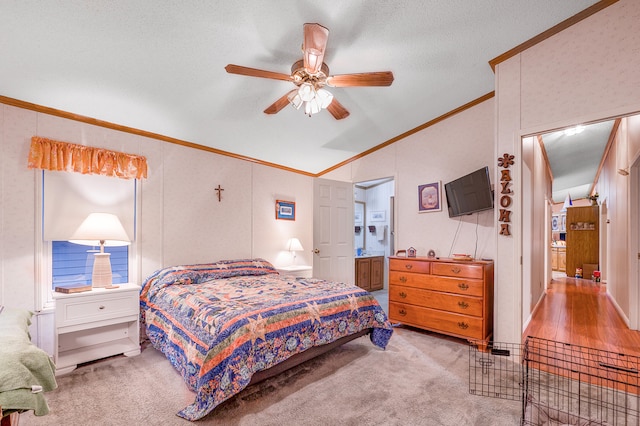 carpeted bedroom featuring connected bathroom, ceiling fan, crown molding, vaulted ceiling, and a textured ceiling