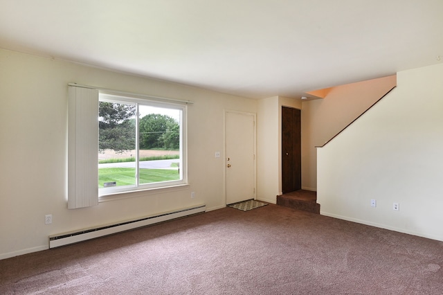 interior space with dark colored carpet and a baseboard heating unit