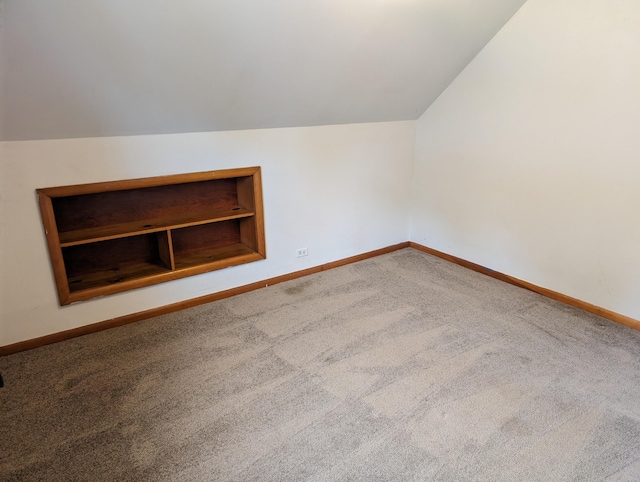 additional living space with carpet floors and lofted ceiling