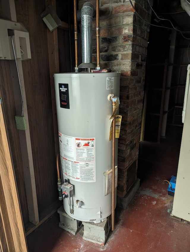 utility room featuring gas water heater