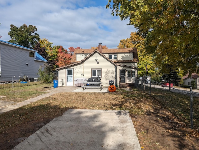 back of house featuring a yard and a patio area