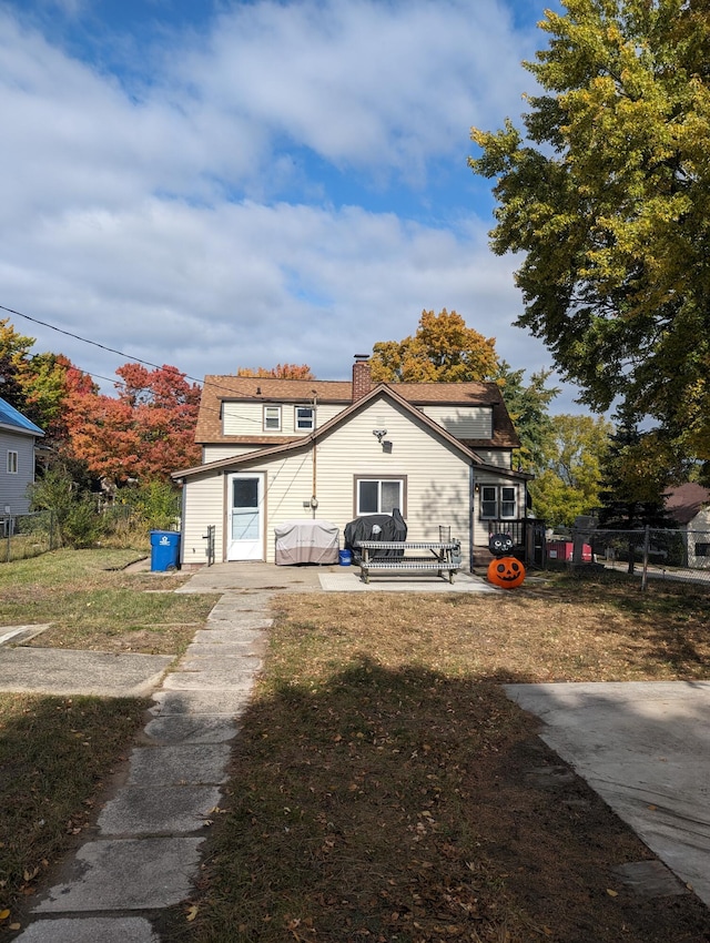 rear view of property with a lawn