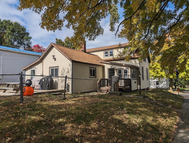 rear view of property with a lawn