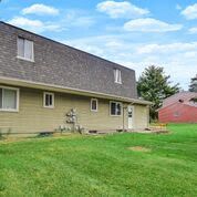 rear view of house with a yard