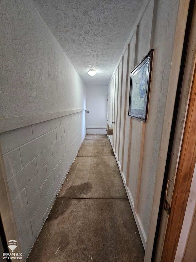 corridor featuring a textured ceiling