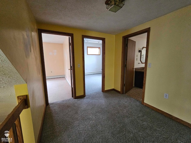 hallway with a textured ceiling and a baseboard radiator