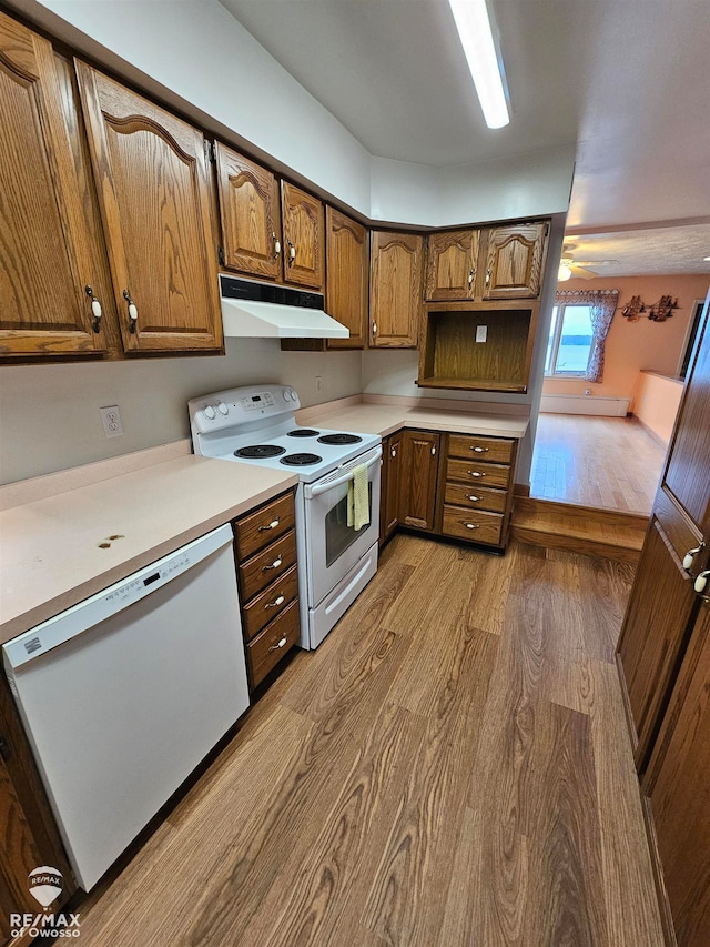 kitchen featuring wood-type flooring and white appliances