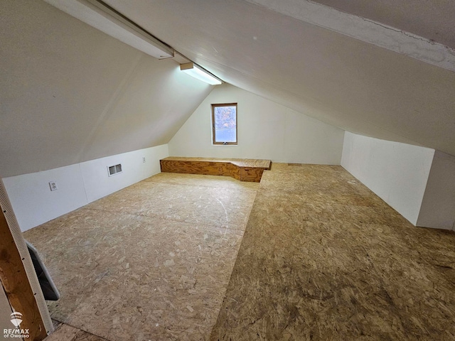 additional living space featuring vaulted ceiling