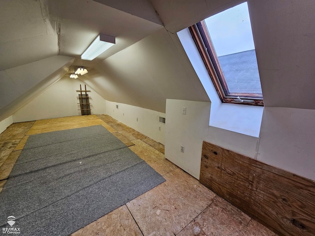 additional living space featuring lofted ceiling