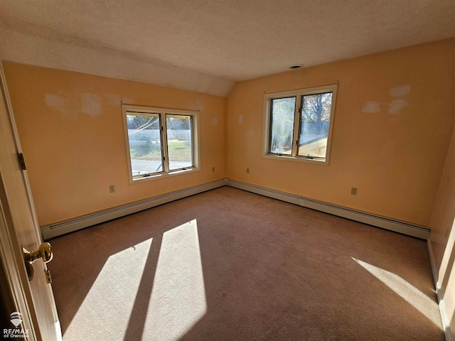 spare room featuring a baseboard heating unit, a textured ceiling, light colored carpet, and lofted ceiling