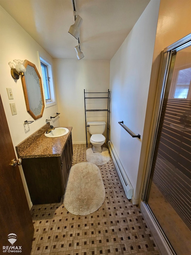 bathroom featuring vanity, a baseboard radiator, toilet, and a shower with shower door