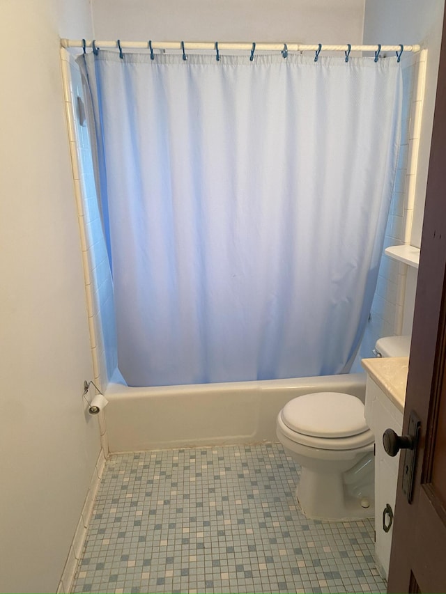 bathroom with tile patterned floors, shower / bath combo with shower curtain, and toilet