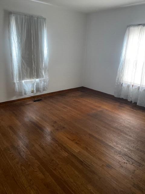 empty room featuring dark wood-type flooring