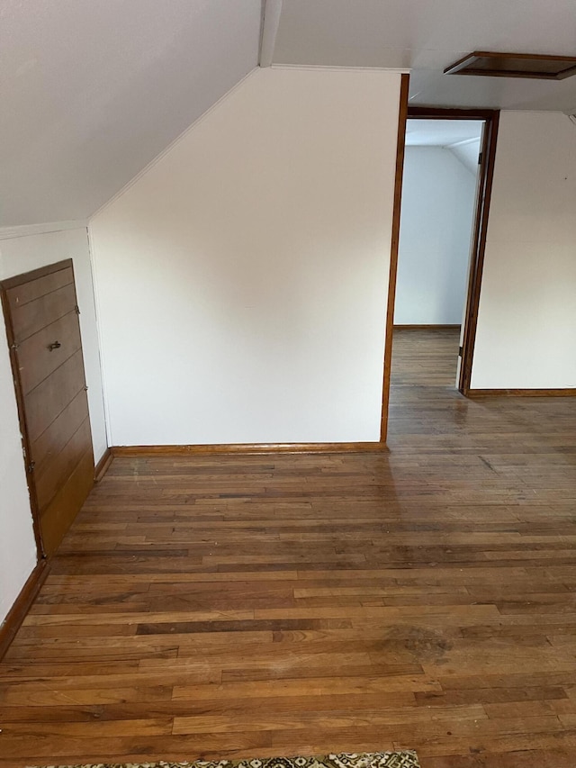 bonus room featuring dark hardwood / wood-style flooring and vaulted ceiling