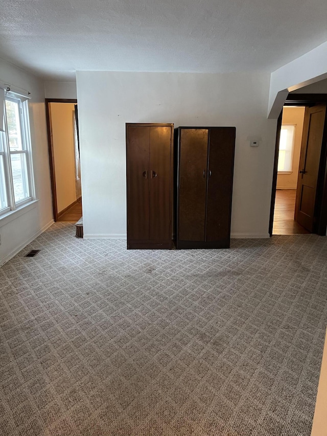 unfurnished bedroom with light colored carpet