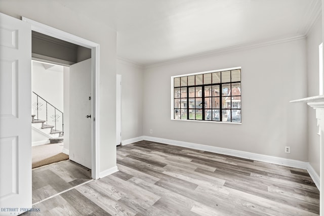 spare room with crown molding and light hardwood / wood-style floors