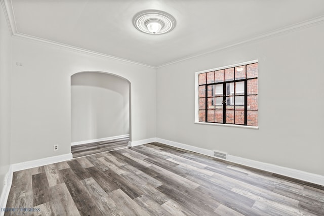 unfurnished room with hardwood / wood-style flooring and ornamental molding