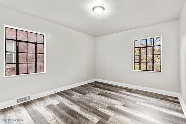 unfurnished room with hardwood / wood-style floors