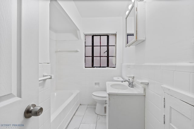 bathroom with a tub to relax in, vanity, toilet, and tile walls