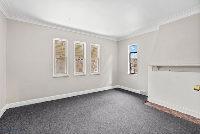 carpeted empty room featuring crown molding