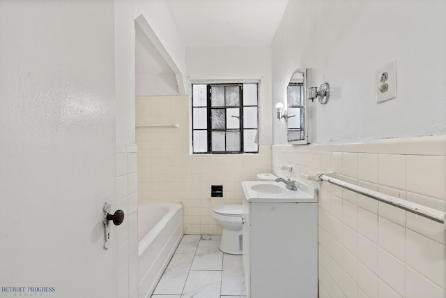 bathroom featuring vanity, a bathing tub, tile walls, and toilet