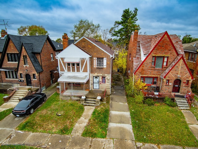 tudor home with a front yard