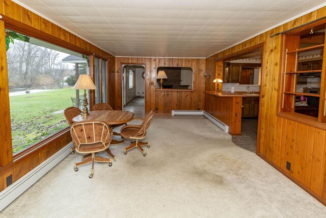 21734 N Channel Pkwy, Edwardsburg, MI 49112 - dining area with a baseboard radiator, wooden walls, light colored carpet, arched walkways, and baseboard heating