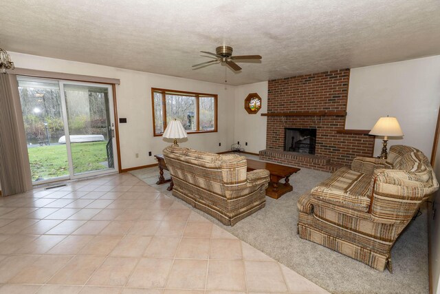 21734 N Channel Pkwy, Edwardsburg, MI 49112 - tiled living area featuring a ceiling fan, a brick fireplace, a textured ceiling, and baseboards